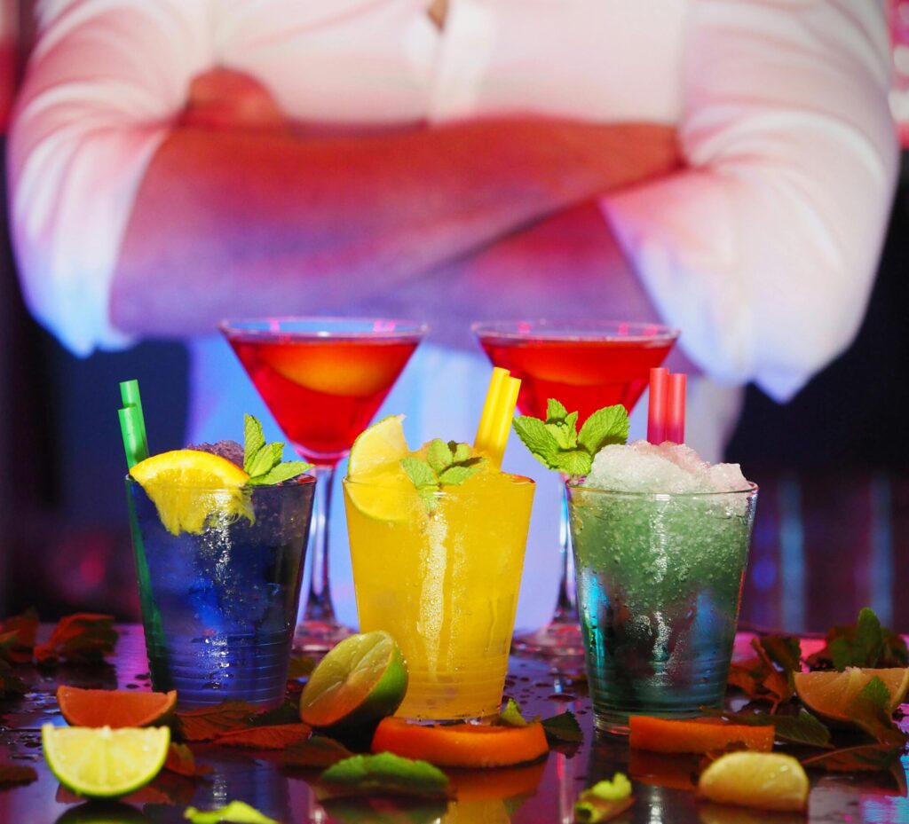 pexels-photo-110472-110472 Colorful cocktails with citrus slices on a bar, perfect for nightlife settings.